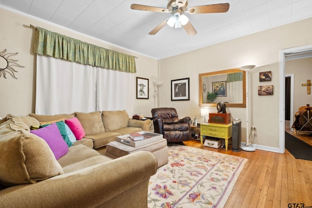 living room with light hardwood / wood-style floors, ceiling fan, and crown molding