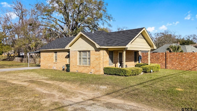 view of side of home with a yard