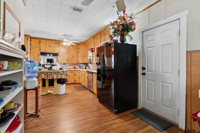 kitchen featuring black refrigerator with ice dispenser, stainless steel dishwasher, and light wood-type flooring