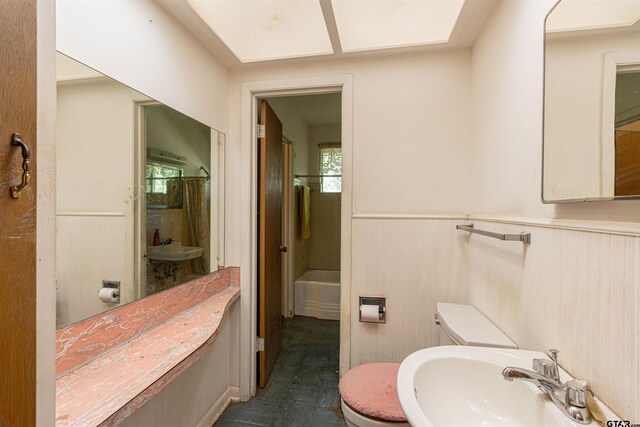 3131 Greg Ln, Tyler, TX 75701 - full bathroom with a wainscoted wall, a tub, and a shower