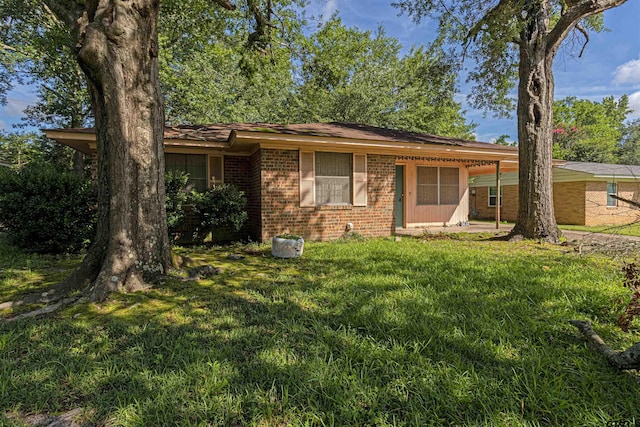 3131 Greg Ln, Tyler, TX 75701 - ranch-style home with brick siding and a front yard
