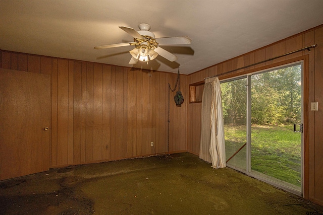 3131 Greg Ln, Tyler, TX 75701 - spare room with carpet floors, wood walls, and ceiling fan