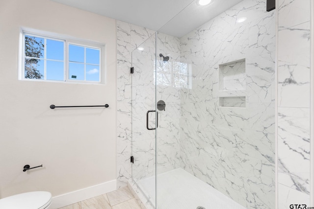 bathroom featuring tile patterned flooring, toilet, and a shower with door