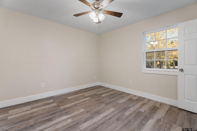 spare room with ceiling fan and hardwood / wood-style floors