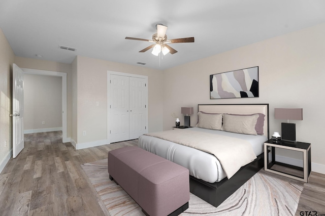 bedroom featuring ceiling fan, a closet, and light hardwood / wood-style floors