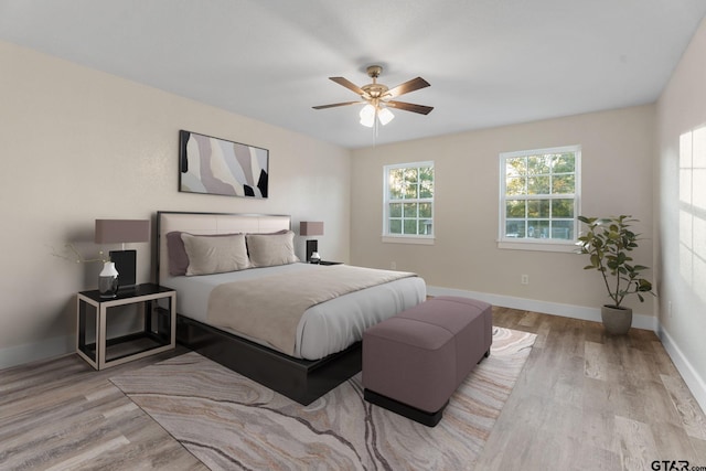 bedroom with light wood-type flooring and ceiling fan