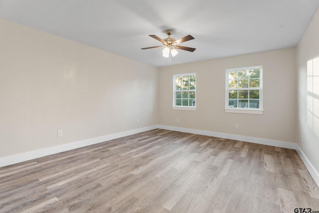 spare room with light wood-type flooring and ceiling fan