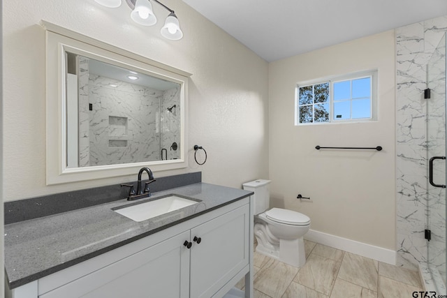 bathroom featuring vanity, toilet, and a shower with shower door