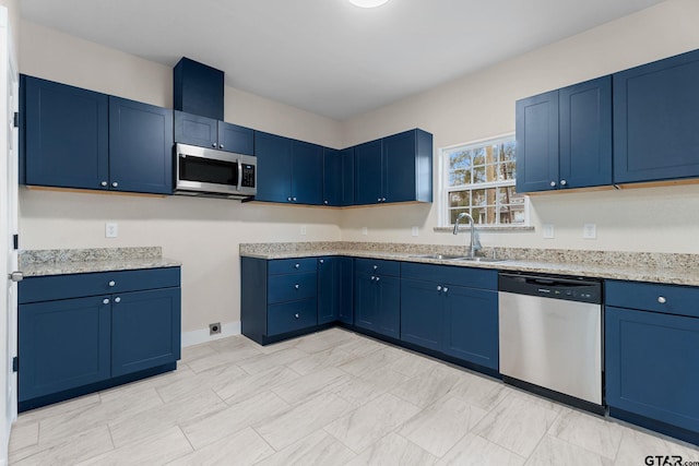 kitchen featuring light stone countertops, sink, blue cabinets, and appliances with stainless steel finishes