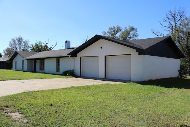 single story home featuring a garage and a front lawn