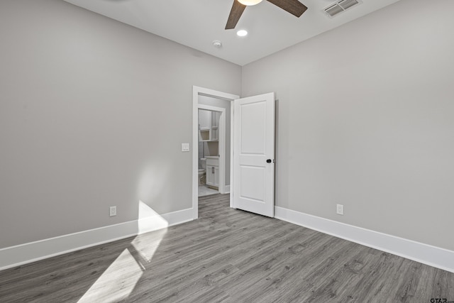 spare room featuring wood-type flooring and ceiling fan