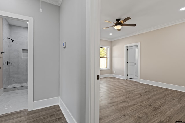 hallway featuring ornamental molding and wood-type flooring