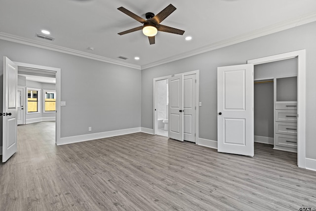 unfurnished bedroom with crown molding, ceiling fan, ensuite bathroom, and light wood-type flooring