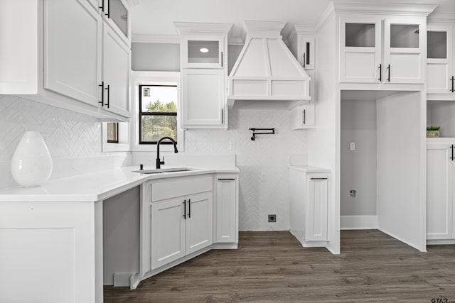 kitchen featuring tasteful backsplash, white cabinetry, sink, and dark hardwood / wood-style floors