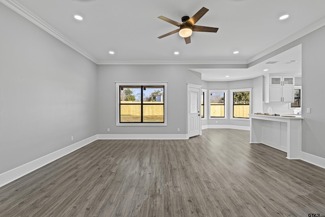 unfurnished living room featuring crown molding, ceiling fan, and dark hardwood / wood-style flooring