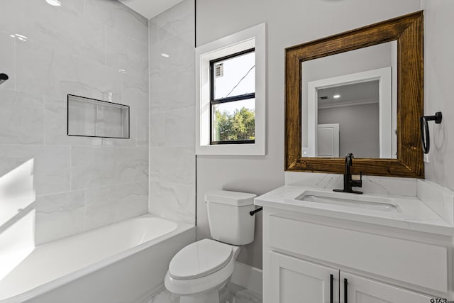 full bathroom featuring tiled shower / bath, vanity, toilet, and ornamental molding