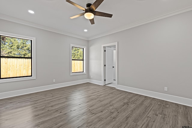 unfurnished room featuring ornamental molding, dark wood-type flooring, and ceiling fan