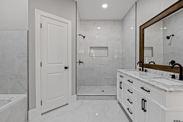 bathroom with vanity and a tile shower