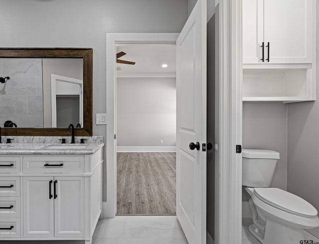 bathroom featuring vanity, ornamental molding, and toilet