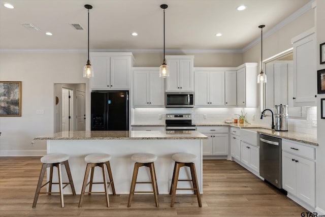 kitchen featuring white cabinetry, a center island, and stainless steel appliances