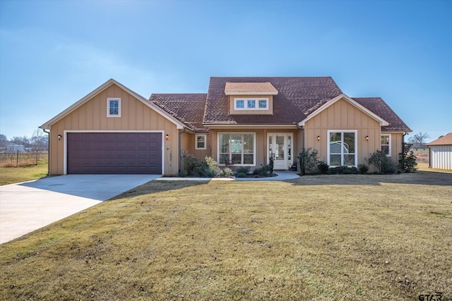 view of front of home with a garage and a front lawn