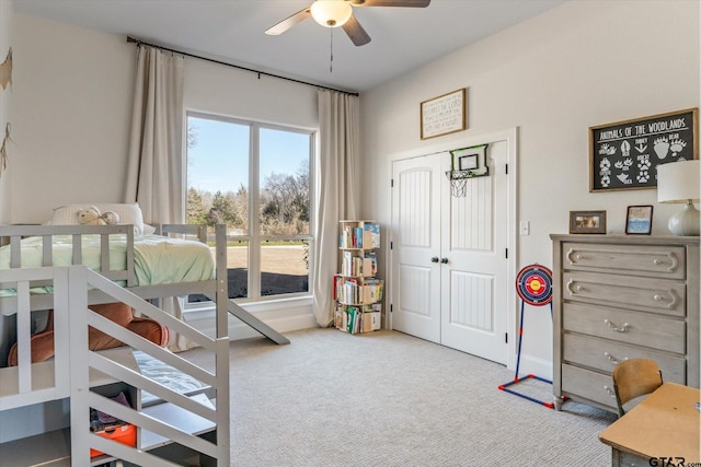 bedroom with light carpet, a closet, and ceiling fan