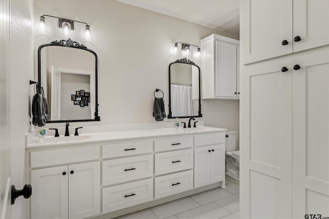 bathroom featuring tile patterned flooring, vanity, and toilet