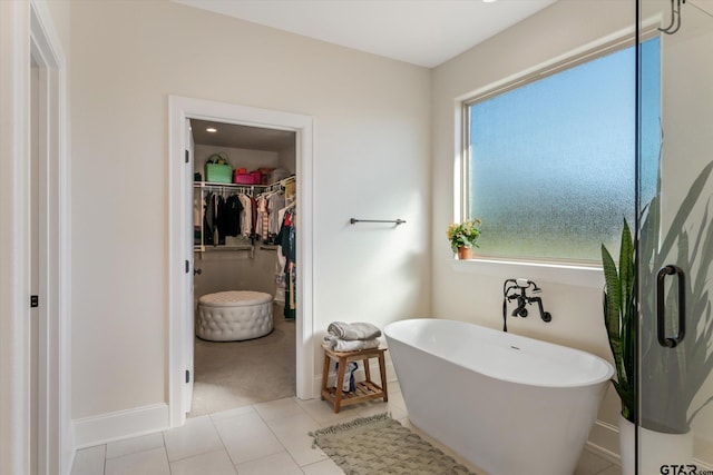 bathroom featuring tile patterned flooring and a bath