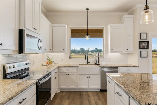 kitchen with white cabinets, sink, stainless steel appliances, and hanging light fixtures