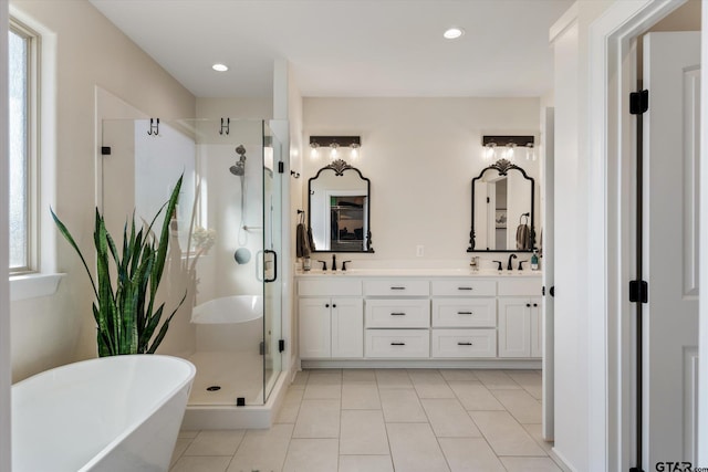 bathroom with tile patterned flooring, vanity, a healthy amount of sunlight, and independent shower and bath