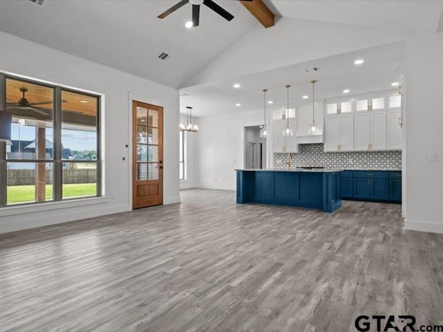 12237 Harlon St, Flint, TX 75762 - kitchen featuring white cabinetry, light wood-style floors, open floor plan, and ceiling fan with notable chandelier
