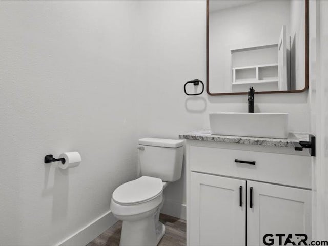 12237 Harlon St, Flint, TX 75762 - half bathroom featuring vanity, toilet, wood finished floors, and baseboards