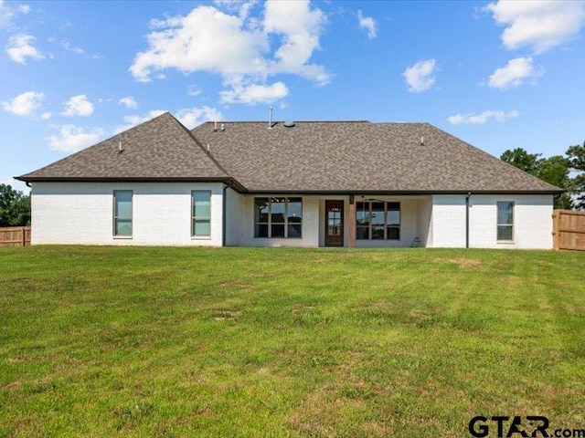 12237 Harlon St, Flint, TX 75762 - back of house featuring a yard, roof with shingles, and fence