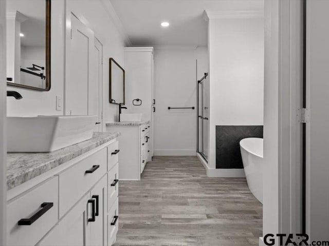 12237 Harlon St, Flint, TX 75762 - full bath with a shower stall, two vanities, crown molding, and wood finished floors