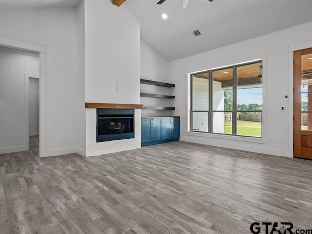 12237 Harlon St, Flint, TX 75762 - unfurnished living room featuring visible vents, high vaulted ceiling, a healthy amount of sunlight, and wood finished floors