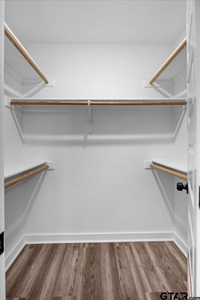 walk in closet featuring hardwood / wood-style floors