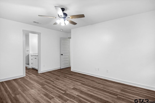 unfurnished bedroom featuring dark hardwood / wood-style floors, ceiling fan, and ensuite bathroom