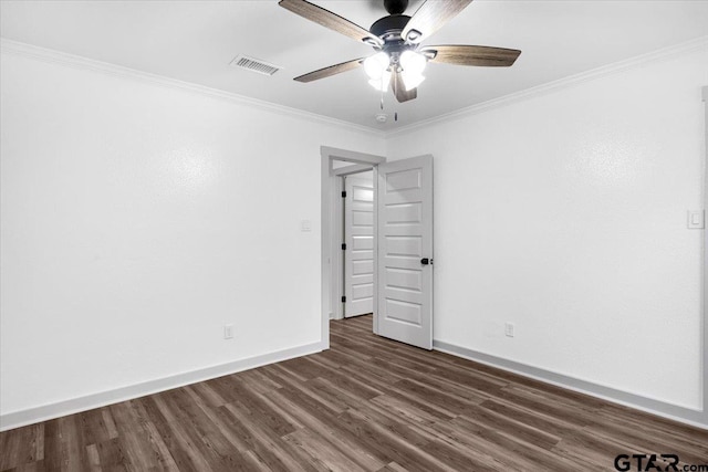 spare room with dark hardwood / wood-style flooring, ornamental molding, and ceiling fan