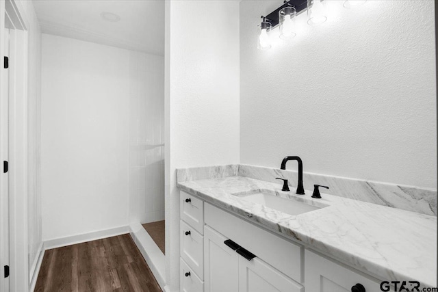 bathroom with vanity, hardwood / wood-style floors, and a shower