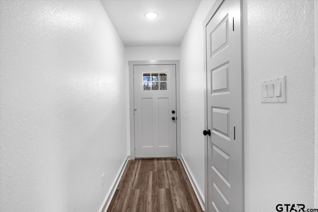 doorway with dark hardwood / wood-style floors