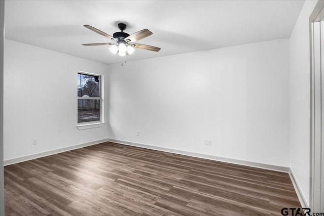 spare room with ceiling fan and dark hardwood / wood-style floors