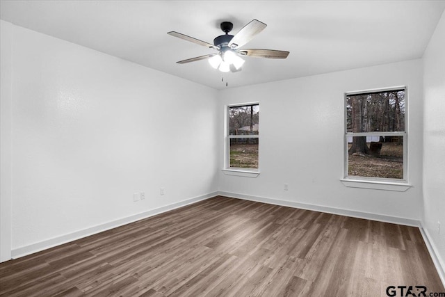 empty room featuring hardwood / wood-style flooring and ceiling fan