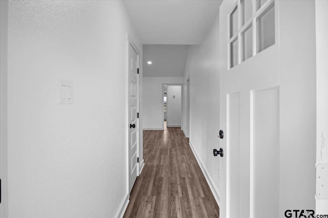 hallway featuring dark wood-type flooring