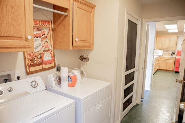 laundry area with cabinets and washing machine and clothes dryer