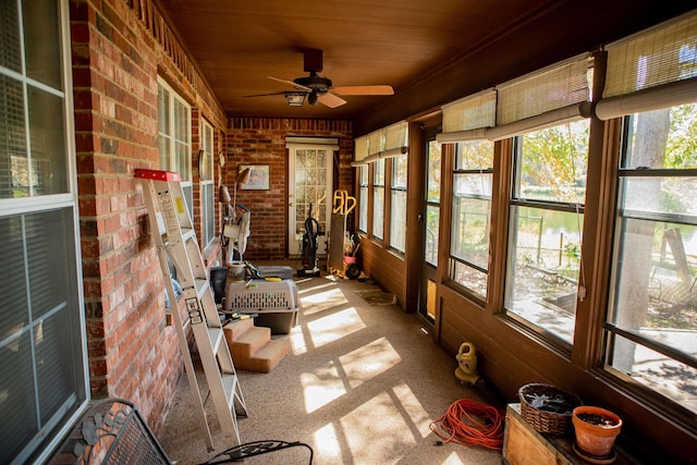 sunroom featuring a wealth of natural light, ceiling fan, and wood ceiling