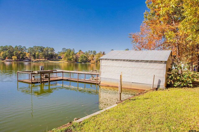 dock area featuring a yard and a water view