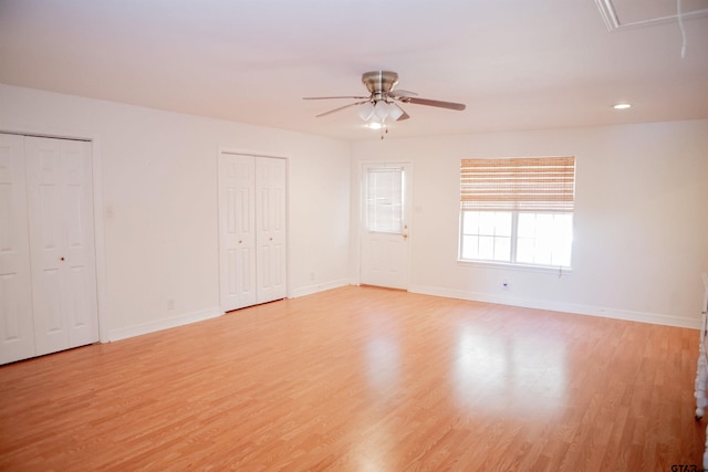 unfurnished room with light wood-type flooring and ceiling fan