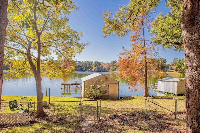 view of yard featuring a water view and a boat dock