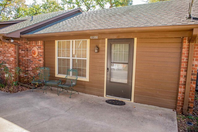 entrance to property with a patio