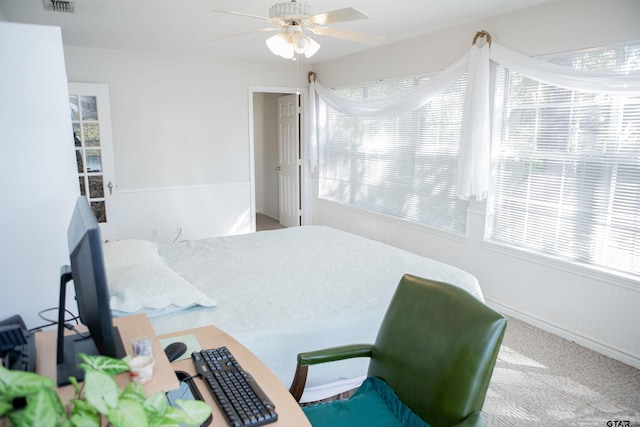 bedroom with carpet flooring, multiple windows, and ceiling fan